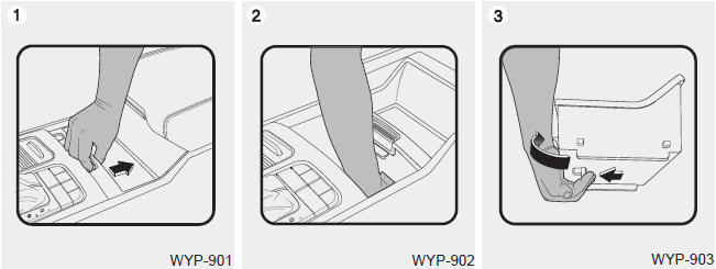 Kia Carnival: Center console storage. ➀ Pull down the knob to slide the sliding tray.